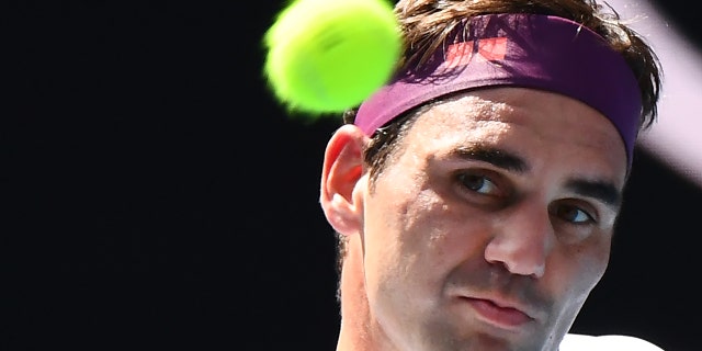 Roger Federer of Switzerland strikes back against Tennis Sandgren of the United States during the men's singles quarterfinal match on day nine of the Australian Open in Melbourne January 28, 2020.