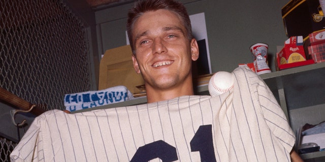 Roger Maris displays the ball he blasted for his 61st home run of the season.