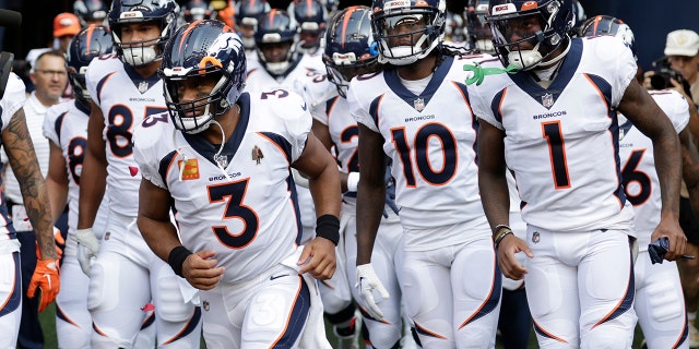 Denver Broncos quarterback Russell Wilson, #3, runs out of the tunnel with teammates at the start of an NFL football game against the Seattle Seahawks, Monday, Sept. 12, 2022, in Seattle.