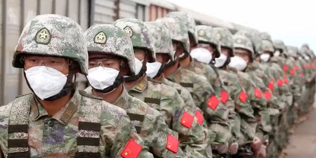 In this handout photo taken from video released by Russian Defense Ministry Press Service on Monday, Aug. 29, 2022, Chinese soldiers arrive to the Grodekovo railway station to participate in war games drills, in Grodekovo, Primorsky Krai, Russia.