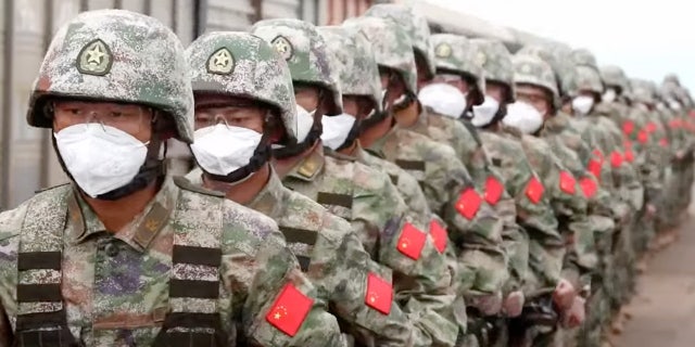 In this handout photo taken from video released by Russian Defense Ministry Press Service on Monday, Aug. 29, 2022, Chinese soldiers arrive to the Grodekovo railway station to participate in war games drills, in Grodekovo, Primorsky Krai, Russia.