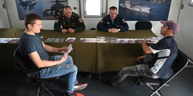 Men visit a mobile recruitment center for military service under contract in Rostov-on-Don, Russia, Sept. 17, 2022. 