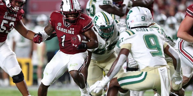 South Carolina running back MarShawn Lloyd (1) looks for running room against Charlotte defensive back Valerian Agbaw (9) during the first half of an NCAA college football game Saturday, Sept. 24, 2022 in Columbia, S.C.