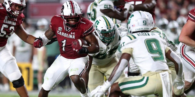 South Carolina running back MarShawn Lloyd (1) looks for running room against Charlotte defensive back Valerian Agbaw (9) during the first half of an NCAA college football game Saturday, Sept. 24, 2022 in Columbia, S.C.