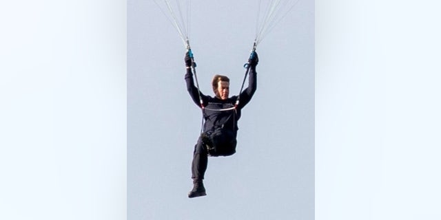 Tom Cruise was seen paragliding from a helicopter in the Lake District.