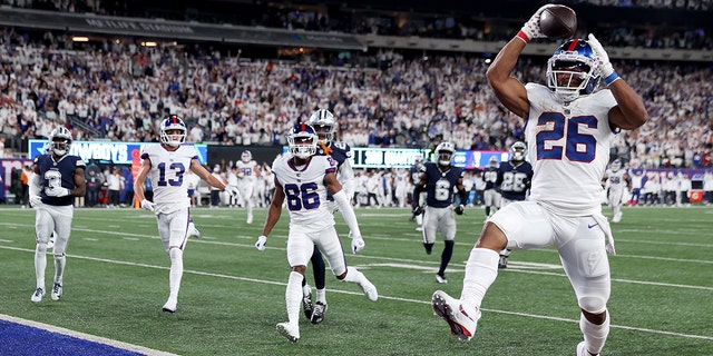 Saquon Barkley (26) of the New York Giants scores a 36-yard touchdown against the Dallas Cowboys during the third quarter in a game at MetLife Stadium Sept. 26, 2022, in East Rutherford, N.J.