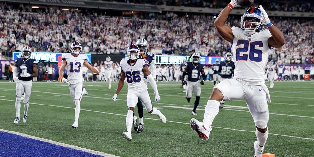 Saquon Barkley (26) of the New York Giants scores a 36-yard touchdown against the Dallas Cowboys during the third quarter in a game at MetLife Stadium Sept. 26, 2022, in East Rutherford, N.J.