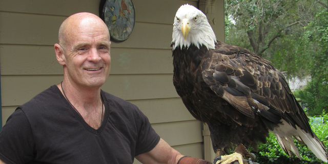Author Jack E. Davis, a professor at the University of Florida, holds a bald eagle. He told Originol Digital, 