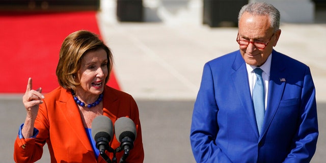 Senate Majority Leader Chuck Schumer of N.Y., listens as House Speaker Nancy Pelosi of Calif., speaks during an event where President Joe Biden will sign H.R. 5376, the Inflation Reduction Act of 2022, on the South Lawn of the White House in Washington, Tuesday, Sept. 13, 2022. 