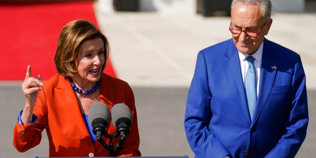 Senate Majority Leader Chuck Schumer, D-N.Y., promised a Senate vote on energy permitting reform to Sen. Joe Manchin, D-W.Va., earlier this year in exchange for his support of the "Inflation Reduction Act." Schumer and House Speaker Nancy Pelosi, D-Calif., appear at a White House ceremony for the bill in this image. 