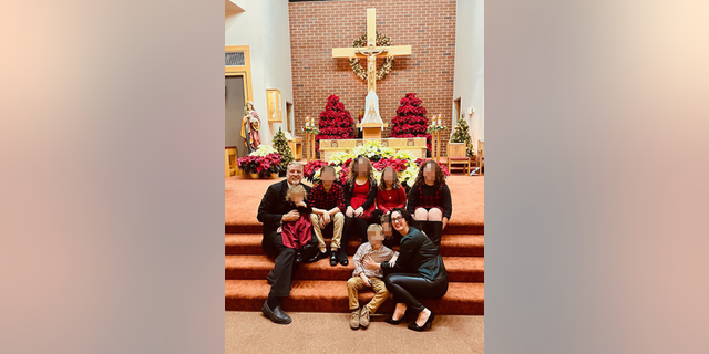 Mark Houck with his family at a Catholic Church. 