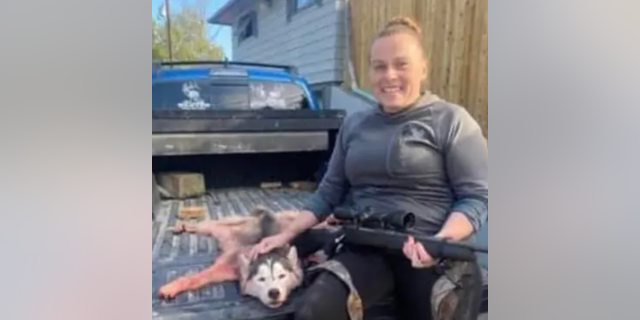 Montana Hunter Amanda Rose Barnes poses with a skinned Siberian Husky.