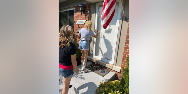 Photo of two women knocking on door in Michigan over abortion ballot measure