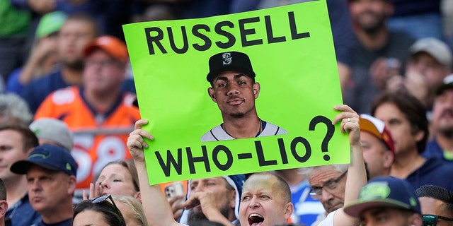 A fan holds up a sign with a photo of Seattle Mariners MLB baseball outfielder Julio Rodriguez that reads 