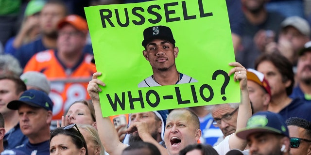 A fan holds up a sign with a photo of Seattle Mariners MLB baseball outfielder Julio Rodriguez that reads