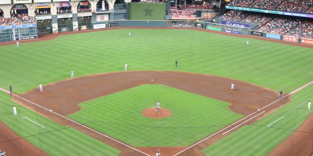 The Los Angeles Dodgers use a defensive switch during a game against the Houston Astros at Minute Maid Park on May 26, 2021 in Houston.