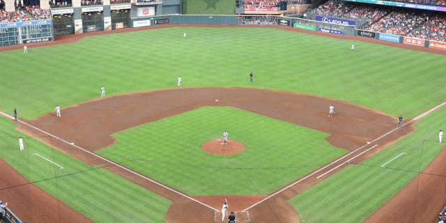 The Los Angeles Dodgers use a defensive switch during a game against the Houston Astros at Minute Maid Park on May 26, 2021 in Houston.
