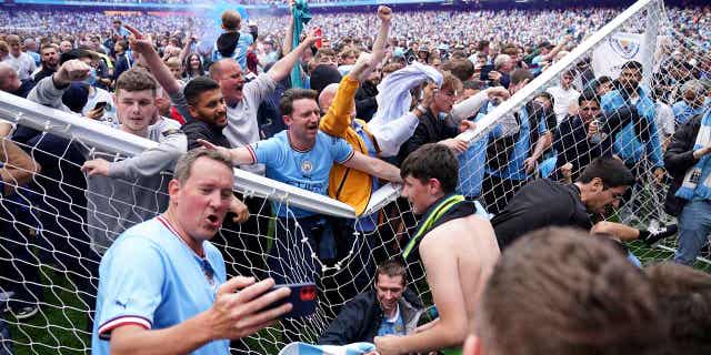 Manchester City fans celebrate after the English Premier League soccer match between Manchester City and Aston Villa in England, on May 22, 2022. The number of field invasions in soccer matches in England and Wales last season increased by 127% compared to the last full campaign before the coronavirus pandemic.