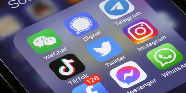 In this photo illustration the logos of social media apps, Instagram, WhatsApp, Messenger, WeChat, Signal, Telegram, TikTok, Twitter and Facebook are displayed on the screen of an iPhone on April 26, 2022 in Paris, France.