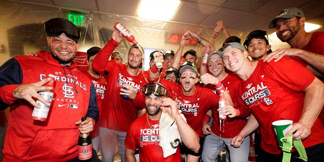 Members of the St. Louis Cardinals celebrate after defeating the Milwaukee Brewers in a baseball game to win the National League Central title Tuesday, Sept. 27, 2022, in Milwaukee.