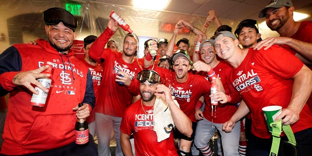 Members of the St. Louis Cardinals celebrate after defeating the Milwaukee Brewers in a baseball game to win the National League Central title Tuesday, Sept. 27, 2022, in Milwaukee.