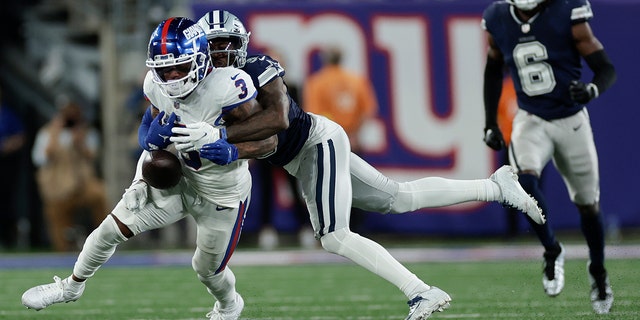 Dallas Cowboys cornerback Anthony Brown (3) strips the ball from New York Giants wide receiver Sterling Shepard (3) during the fourth quarter of a game Monday, Sept. 26, 2022, in East Rutherford, N.J.