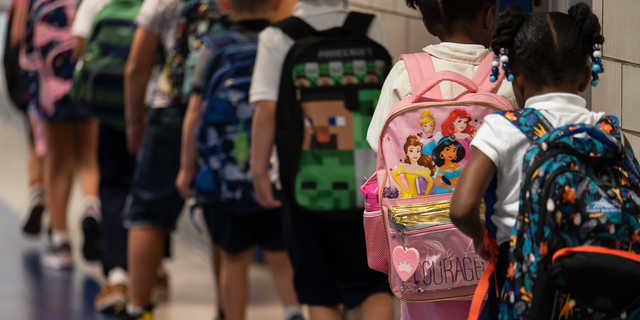 Students line up to enter their classrooms at Lyles-Crouch Traditional Academy in Alexandria, Virginia, on Aug. 19, 2022.