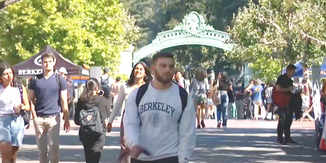 Students walking on a college campus. State tax may be charged on student loan handout funds. 