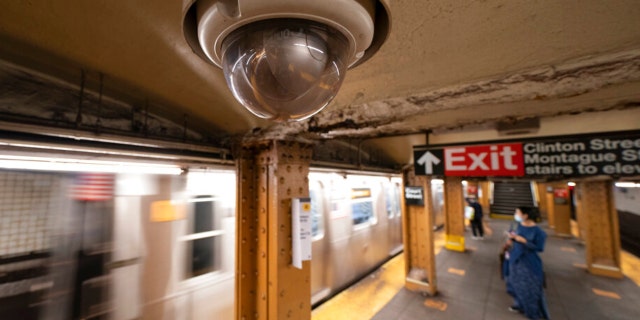 FILE - A video surveillance camera hangs from the ceiling above a subway platform in the Brooklyn borough of New York.