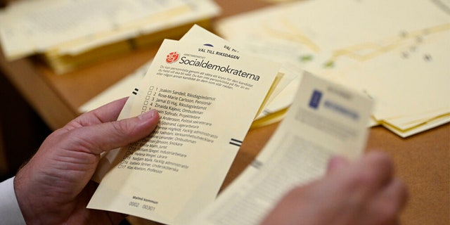 Poll workers count votes at a polling station at Hästhagens Sport Center in Malmö, Sweden, Sunday, Sept. 11, 2022.