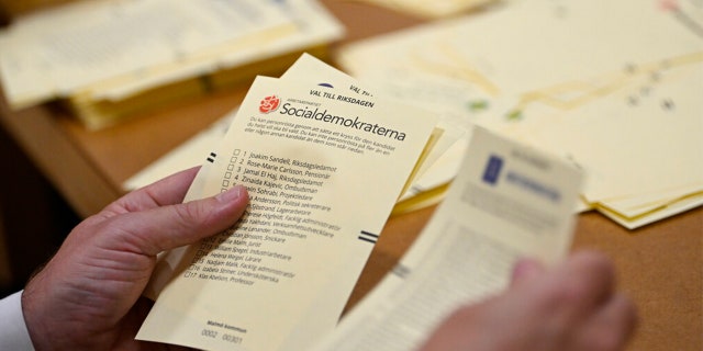 Poll workers count votes at a polling station at Hästhagens Sport Center in Malmö, Sweden, Sunday, Sept. 11, 2022.