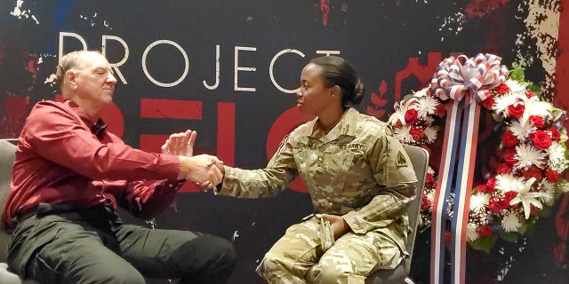 Task Force Tribute leader USMC Ret. Lt. Col Don Richardson (left) interviews U.S. Army National Guard DC Maj. Reneka Remond (right) following the 9/11 memorial ceremony in Washington, D.C., on Sept. 11, 2022.