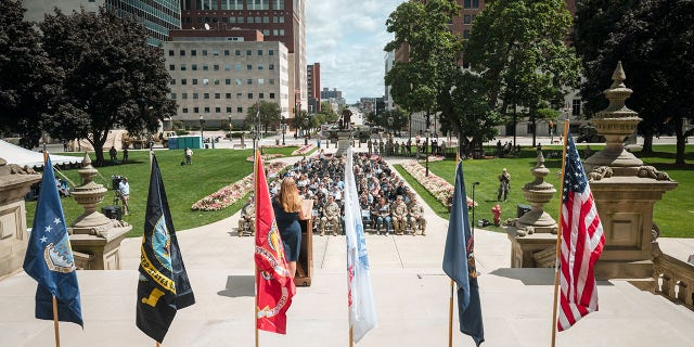 Michelle Anschuetz, co-founder of Project RELO, gives an address during the Task Force Tribute kickoff on the steps of the state capitol building in Lansing, Michigan, on Aug. 21, 2022.