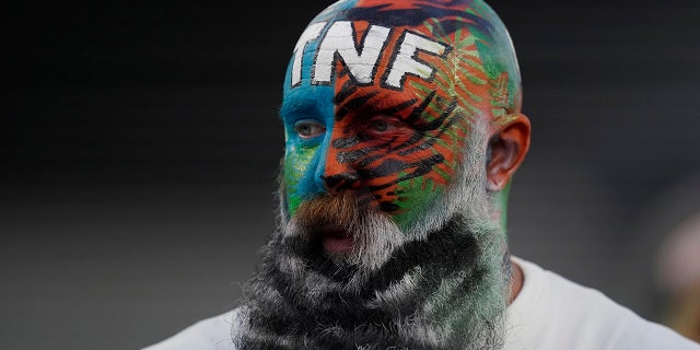 A fan watches as the Cincinnati Bengals and Miami Dolphins warm up for an NFL football game Thursday, Sept. 29, 2022, in Cincinnati.