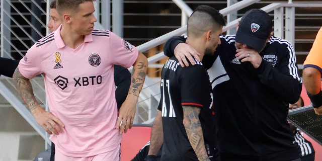 D.C. United head coach Wayne Rooney (R) talks to D.C. United forward Taxiarchis Fountas, #11, after removing him from the game against Inter Miami CF after receiving a yellow card for an incident involving Inter Miami CF defender Damion Lowe (not pictured) in the second half at Audi Field Sept. 18, 2022 in Washington, D.C. 