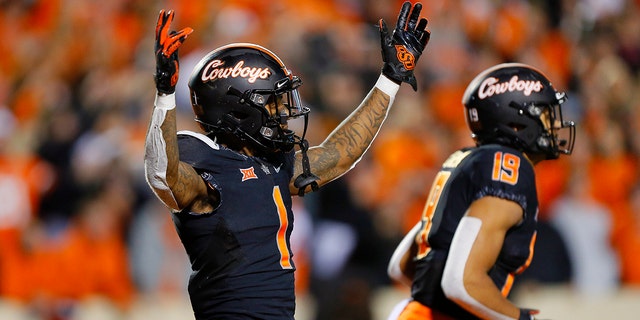 Wide receiver Tay Martin, #1 of the Oklahoma State Cowboys, celebrates a 43-yard touchdown catch with wide receiver Bryson Green, #19, only to have the play ruled incomplete against the Oklahoma Sooners in the fourth quarter at Boone Pickens Stadium on Nov. 27, 2021 in Stillwater, Oklahoma.  