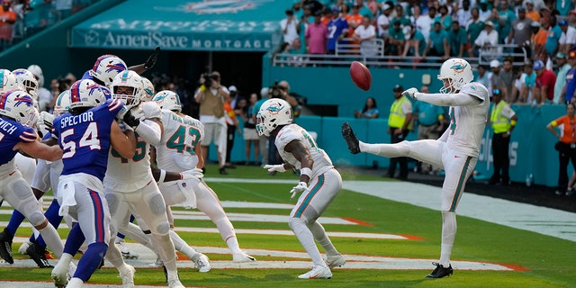 Miami Dolphins punter Thomas Morstead (4) sees the ball go backwards after attempting a punt during the second half of an NFL football game against the Buffalo Bills, Sunday, Sept. 25, 2022, in Miami Gardens, Fla.