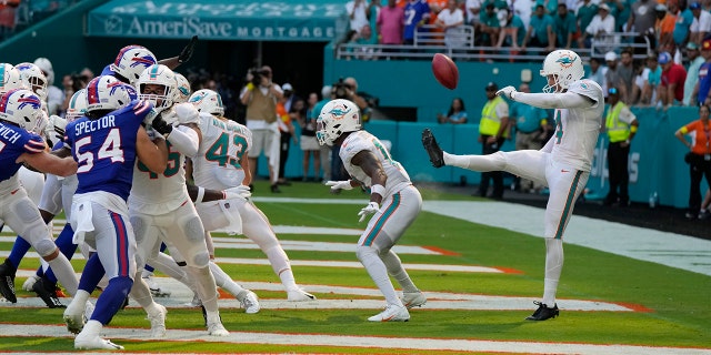 Miami Dolphins punter Thomas Morstead (4) sees the ball go backwards after attempting a punt during the second half of an NFL football game against the Buffalo Bills, Sunday, Sept. 25, 2022, in Miami Gardens, Fla.