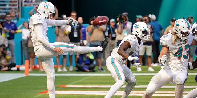 Sep 25, 2022; Miami Gardens, Florida, USA; Miami Dolphins punter Thomas Morstead (4) punts the ball off of the backside of wide receiver Trent Sherfield (14) resulting in the ball going out of bounds and a safety for the Buffalo Bills during the second half at Hard Rock Stadium.