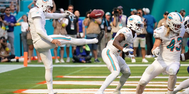 Sep 25, 2022; Miami Gardens, Florida, USA; Miami Dolphins punter Thomas Morstead (4) punts the ball off of the backside of wide receiver Trent Sherfield (14) resulting in the ball going out of bounds and a safety for the Buffalo Bills during the second half at Hard Rock Stadium.