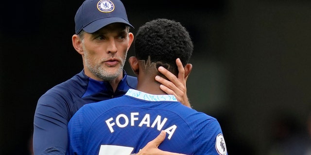 Chelsea's head coach Thomas Tuchel, left, hugs Chelsea's Wesley Fofana during the English Premier League soccer match between Chelsea and West Ham United at Stamford Bridge Stadium in London, on Sept. 3, 2022.