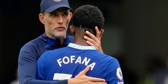 Chelsea's head coach Thomas Tuchel, left, hugs Chelsea's Wesley Fofana during the English Premier League soccer match between Chelsea and West Ham United at Stamford Bridge Stadium in London, on Sept. 3, 2022.