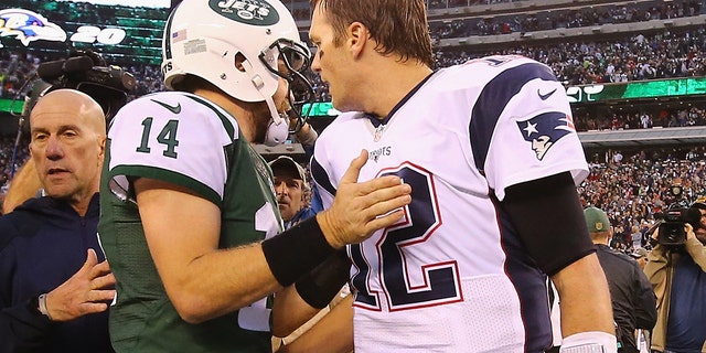 Ryan Fitzpatrick, #14 of the New York Jets, meets Tom Brady, #12 of the New England Patriots, after the Jets 26-20 overtime win at MetLife Stadium on Dec. 27, 2015 in East Rutherford, New Jersey.
