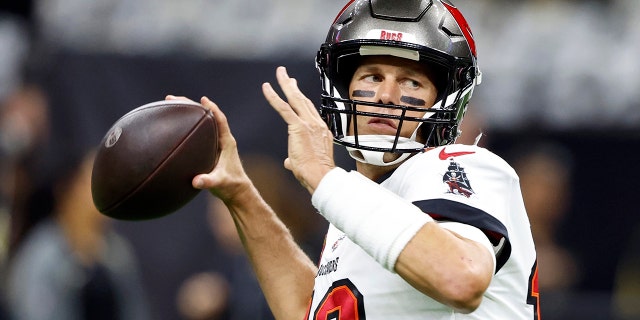 Tampa Bay Buccaneers quarterback Tom Brady warms up before the first half of an NFL football game against New Orleans Saints in New Orleans, Sunday, Sept. 18, 2022.