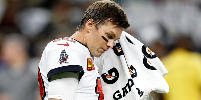 Tom Brady warms up before playing the Saints on Sept. 18, 2022, in New Orleans. He said Monday his daughter often tells him he doesn't have a "happy face" on the field.