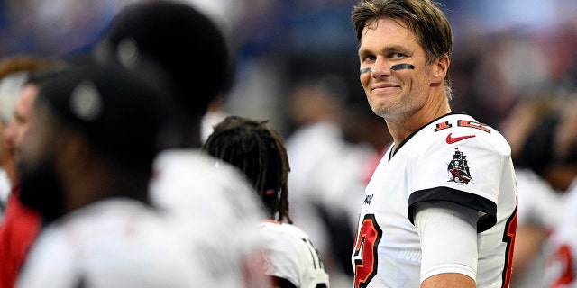 Tom Brady smiles during the national anthem before the game against the Indianapolis Colts on Aug. 27, 2011.