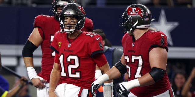 Tom Brady #12 of the Tampa Bay Buccaneers celebrates after throwing a touchdown pass to Mike Evans #13 during the second half against the Dallas Cowboys at AT&amp;T Stadium on September 11, 2022, in Arlington, Texas.