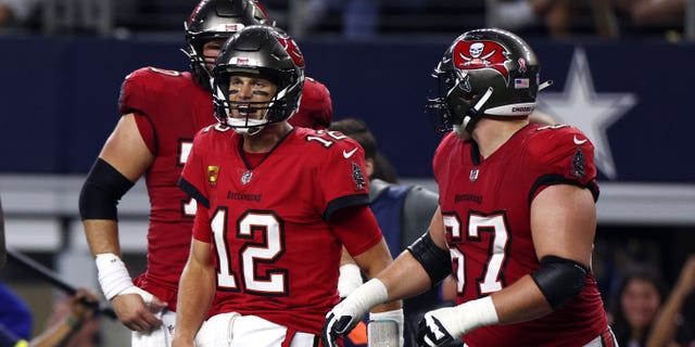 Tom Brady #12 of the Tampa Bay Buccaneers celebrates after throwing a touchdown pass to Mike Evans #13 during the second half against the Dallas Cowboys at AT&amp;T Stadium on September 11, 2022, in Arlington, Texas.