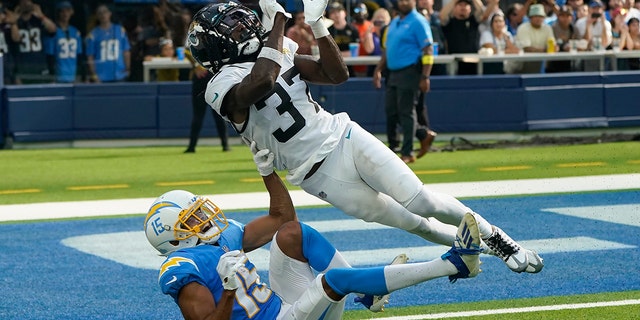 Jacksonville Jaguars cornerback Tre Herndon (37) breaks up a pass intended for Los Angeles Chargers wide receiver Jalen Guyton (15) during the second half of an NFL football game in Inglewood, Calif., Sunday, Sept. 25, 2022. 