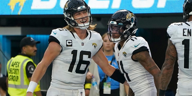 Jacksonville Jaguars quarterback Trevor Lawrence (16) and wide receiver Marvin Jones Jr. celebrate after connecting on a touchdown pass during the second half of an NFL football game against the Los Angeles Chargers in Inglewood, Calif., Sunday, Sept. 25, 2022. 